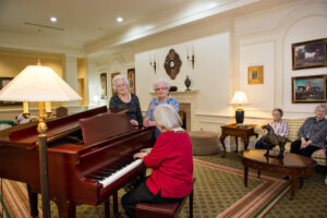 Woman Playing Piano with Woman Watching
