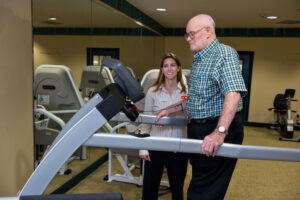 Woman Showing Man Exercise Machine