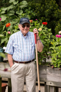 Man Smiling with Shovel Outside