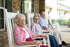 Group of Senior Living Residents Sitting Outside Smiling