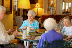 Group of Senior Living Residents Sitting at Table Together