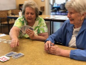 2 Woman Playing Cards Together