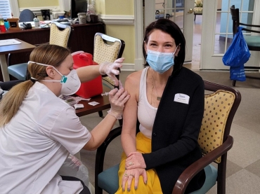 Woman Smiling While Receiving Vaccination